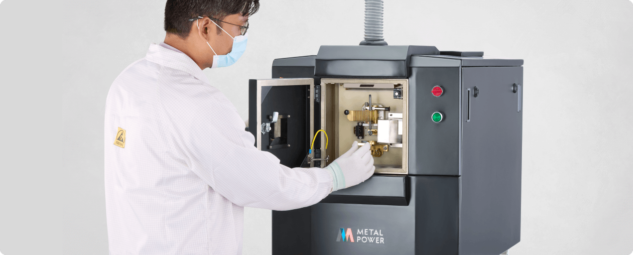 Lab technician using Metal Power spectrometer for metal analysis