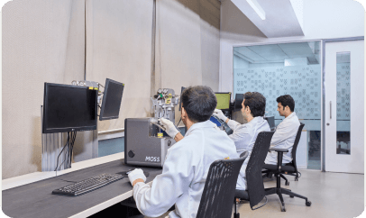 Lab technicians operating analytical instruments